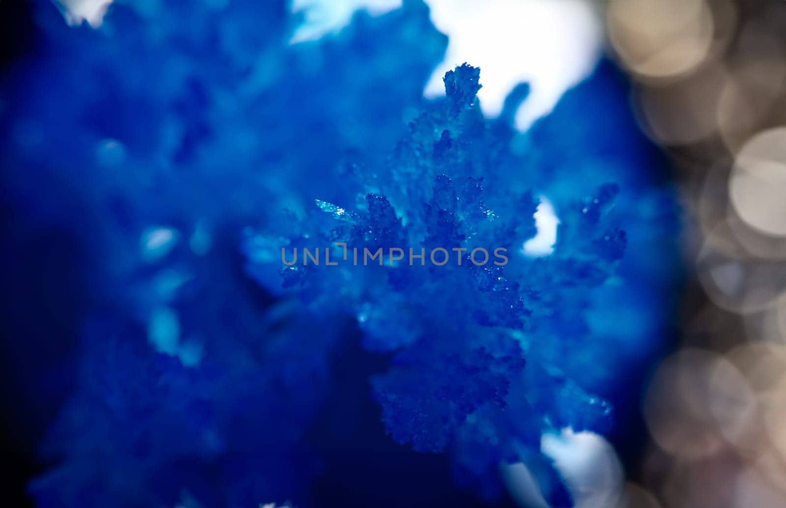 Blue frozen ice in beautiful sapphires and crystals. Frozen natural winter texture. Crystallization of frozen ice during ice season.