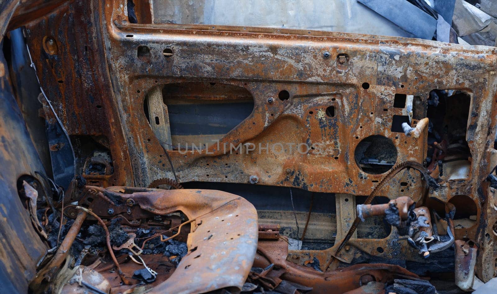 Burnt car after accident. Transport insurance. Old abandoned rusty car concept