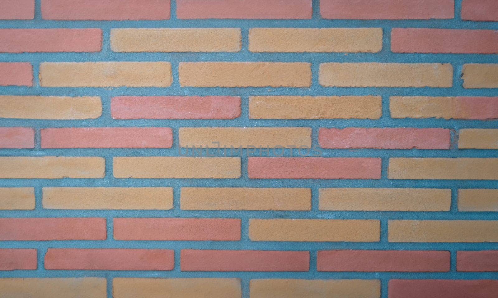 Brown tiles in form of bricks on wall background closeup. Interior design material sale concept