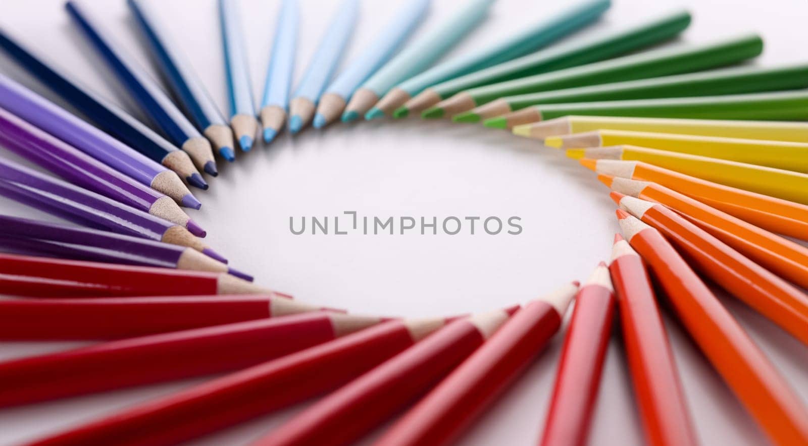 Many multicolored pencils lying in shape of circle closeup. Art education concept