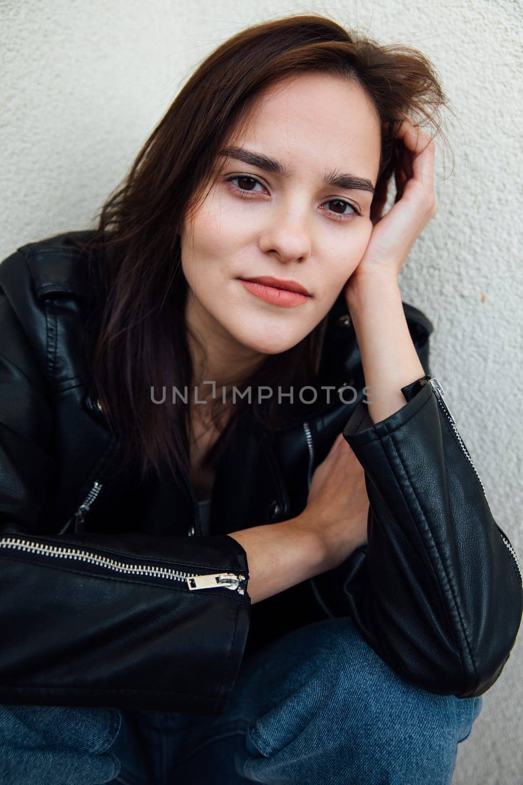 Portrait of a brunette woman with emotions on a light background by Simakov