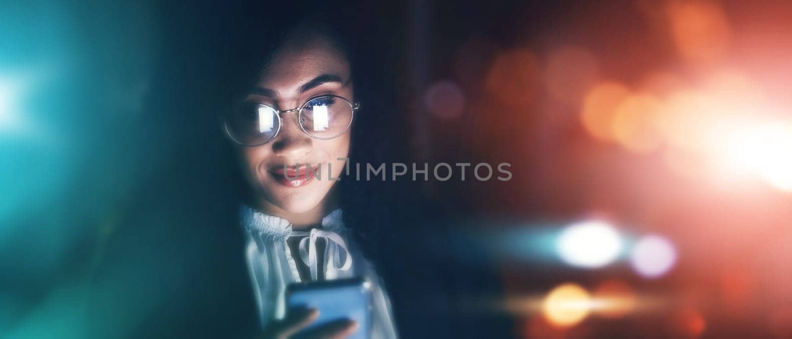 Businesswoman, phone and communication at night for texting, chatting or networking on dark background. Female employee smile holding smartphone working late for online planning strategy on mockup.