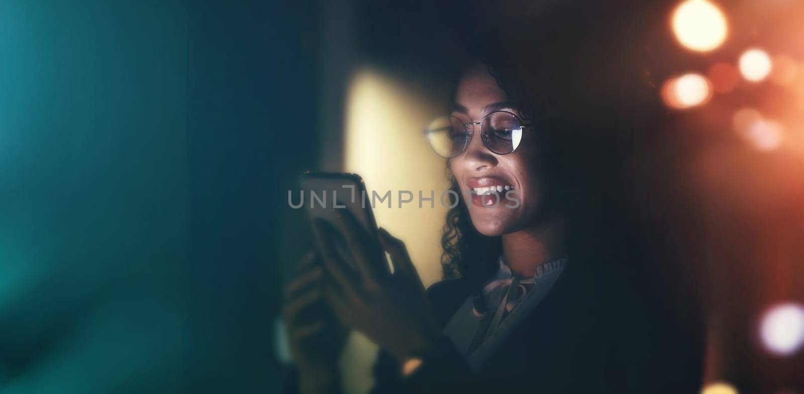 Businesswoman, phone and communication at night for social media, chat or networking on dark background. Female employee smile holding smartphone working late for online planning strategy on mockup.