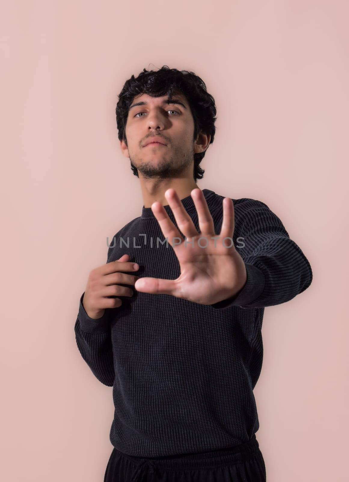 A man making a stop sign with his hands by artofphoto