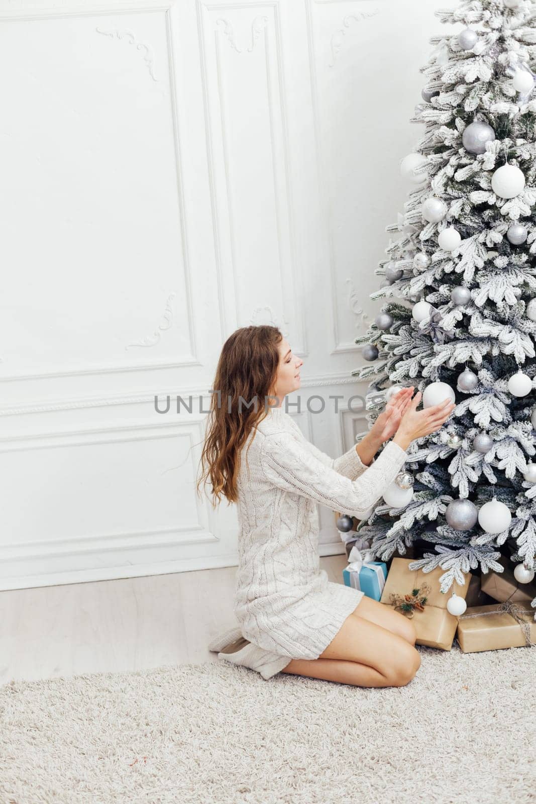 Woman decorating christmas tree for new year