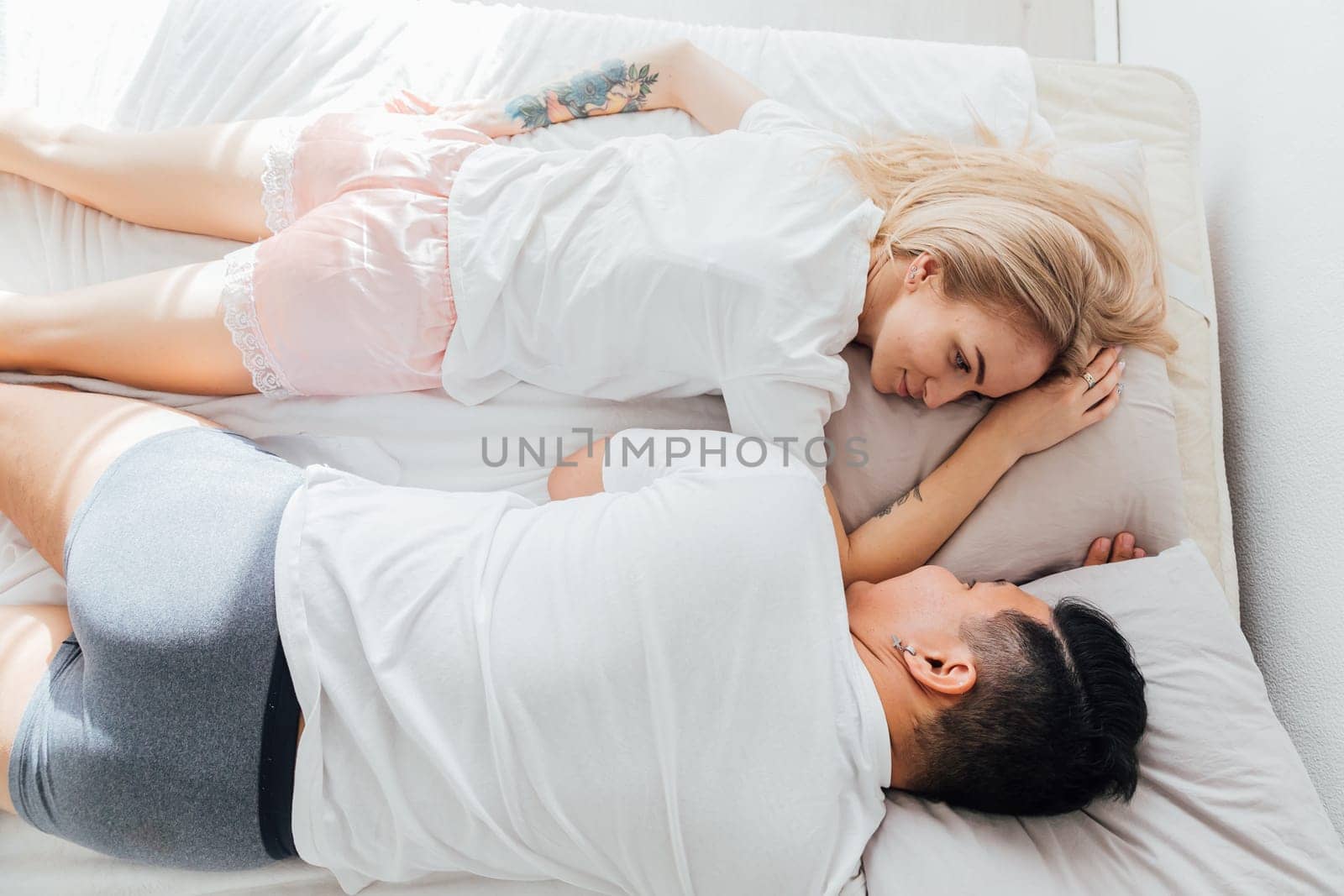 Couple husband and wife in the morning in bed wake up