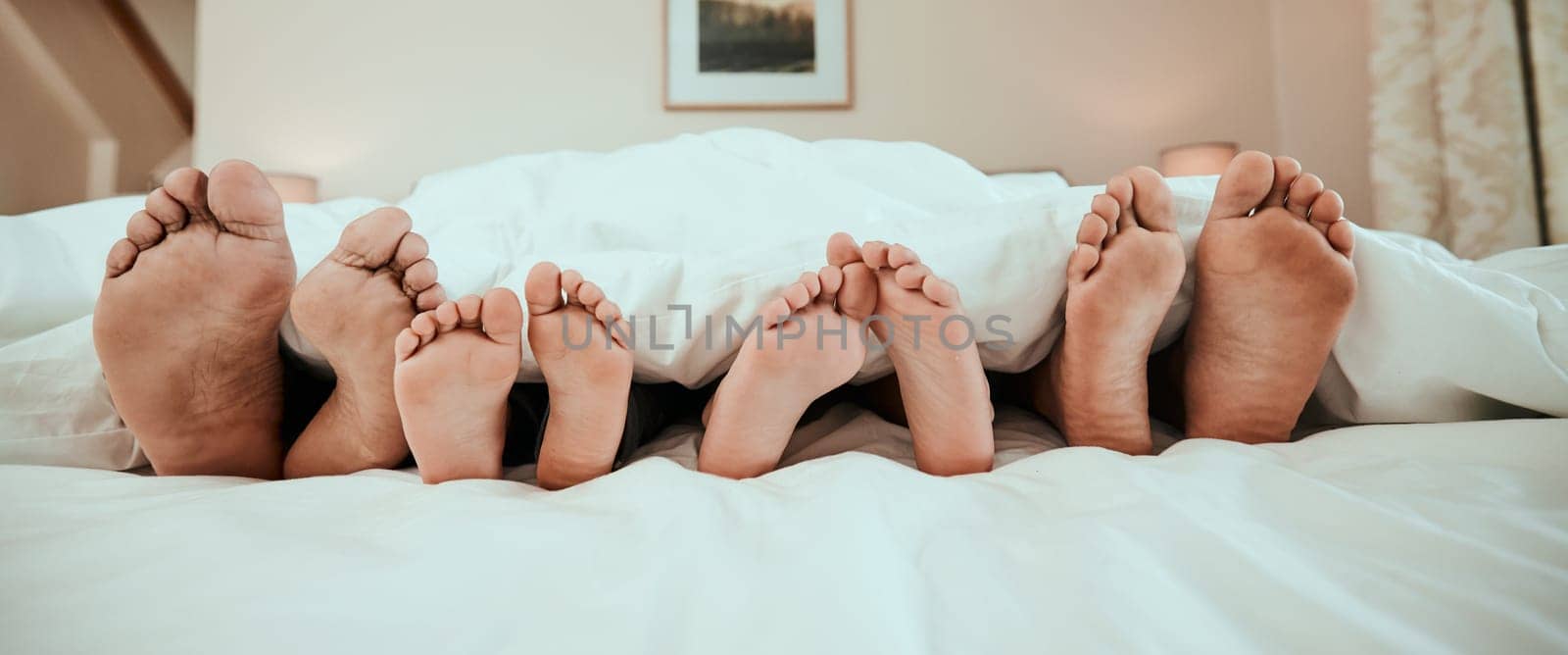 Sleeping, feet and family in bed relax, peaceful and enjoying. a nap in their home together. Foot, sleep and children resting with in parents in a bedroom with love, safety and or vacation freedom by YuriArcurs