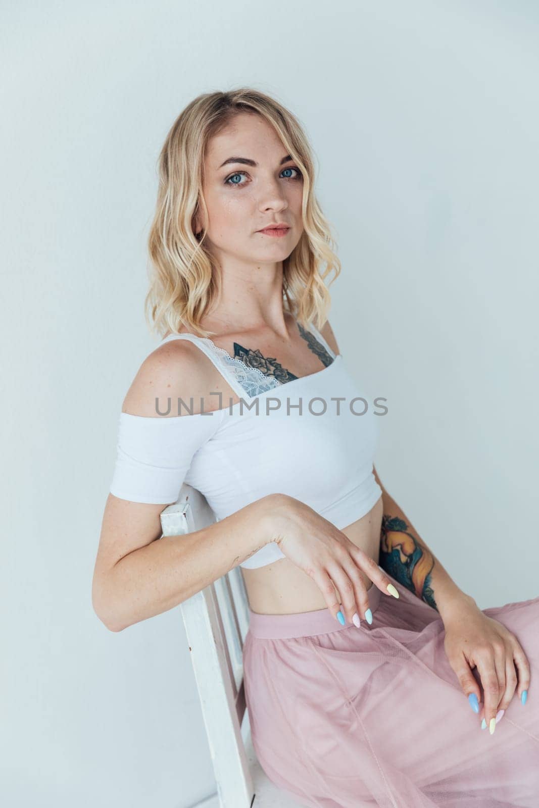 beautiful woman posing on a chair in a bright room