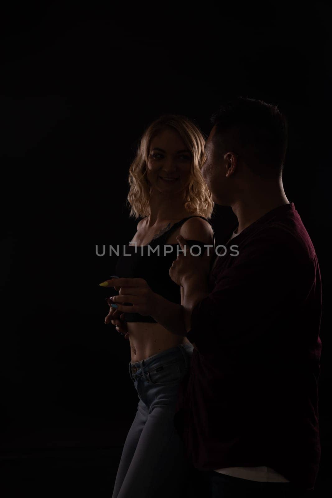 Man and woman dancers in dark