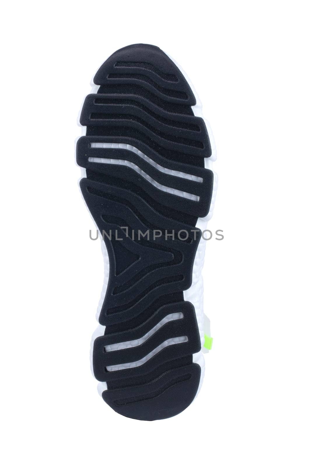 Black rubber sole of the sneaker with white inserts isolated.