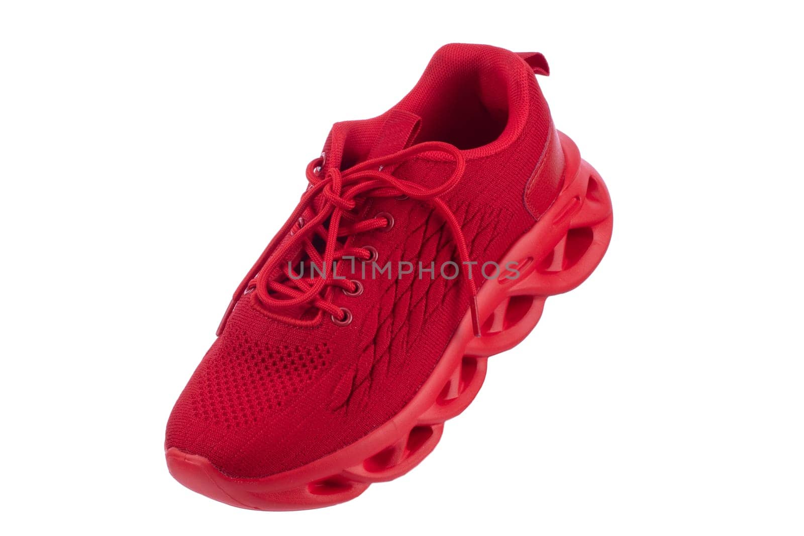 Red sneaker made of fabric on a white background. Sport shoes.