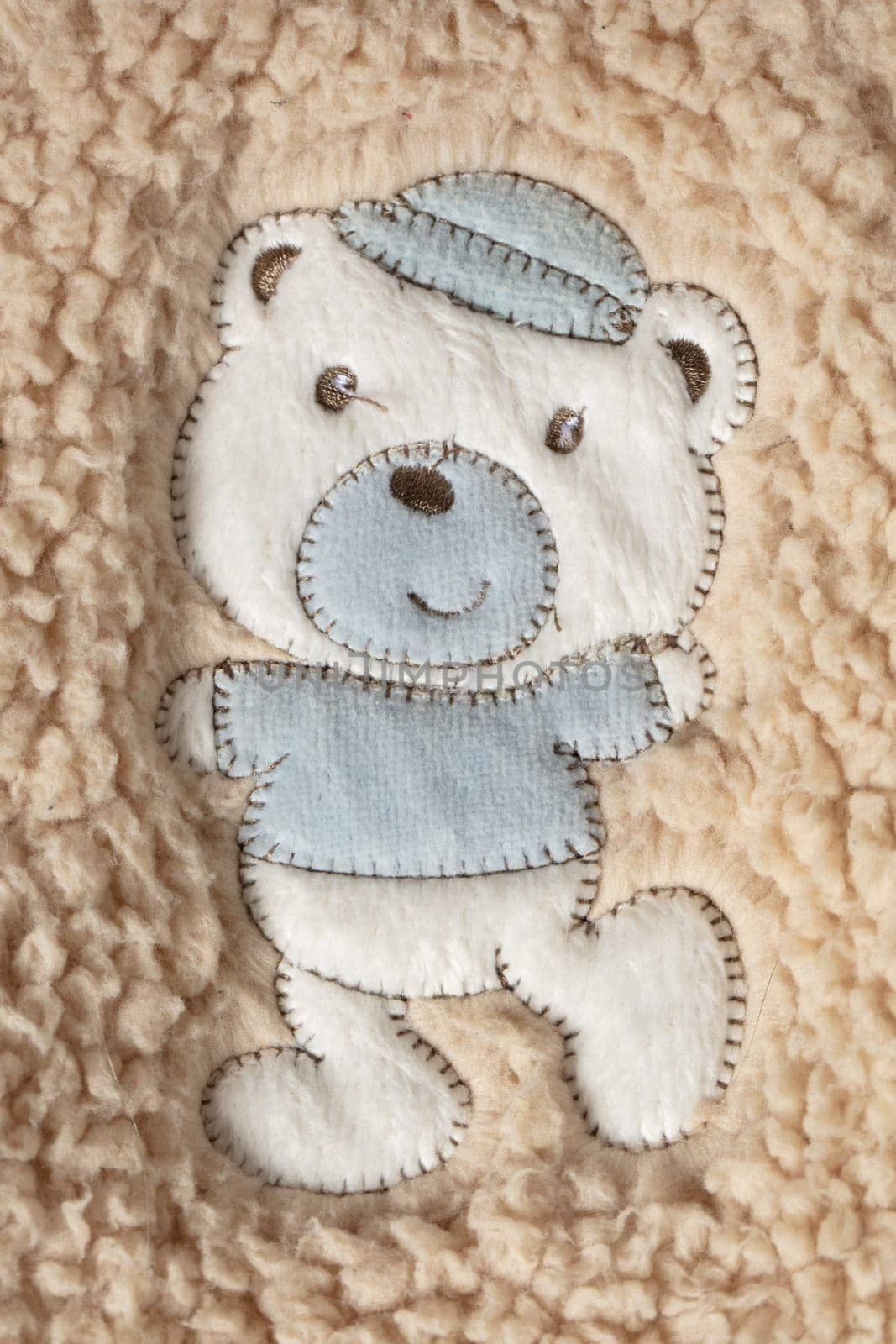 On the fur is a fabric application of a cute teddy bear. by Sviatlana