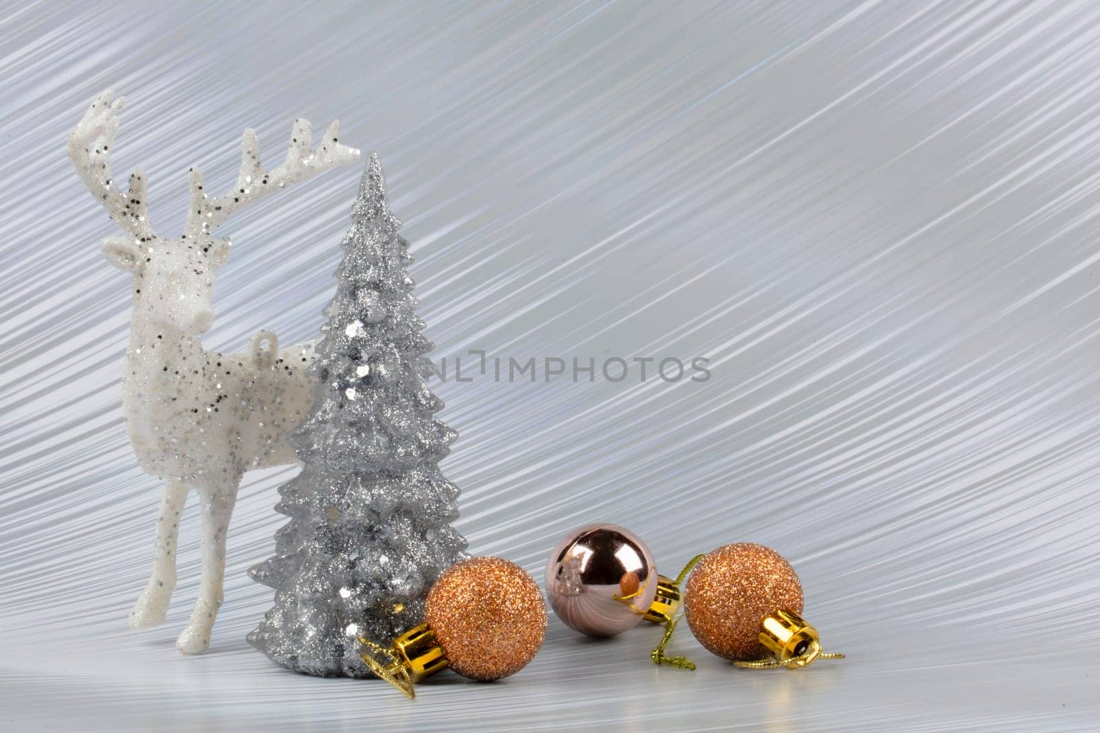 Christmas or New Year background with silver snowy tree and golden transitional decoration, deer. Bright festive background.
