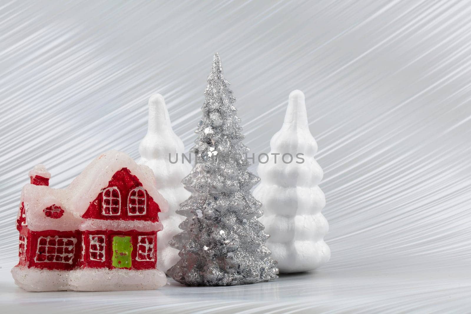 Christmas or New Year background with silver snowy fir tree and red toy house. Bright festive background. by Sviatlana