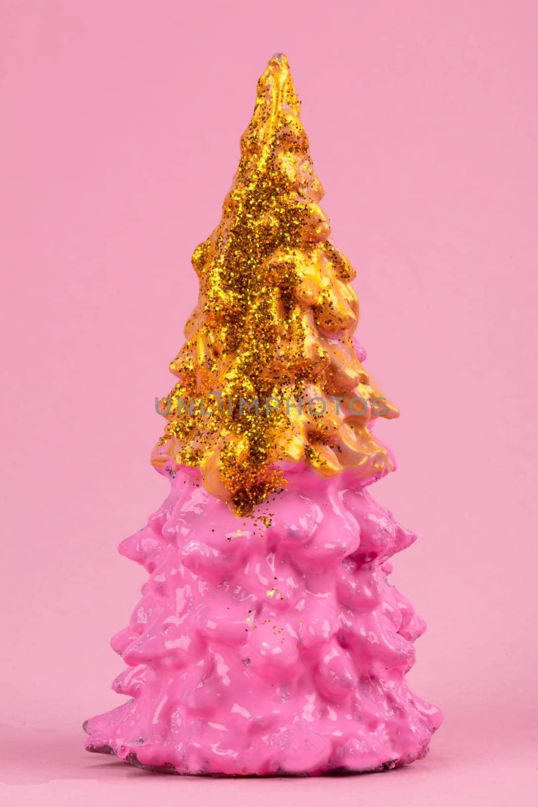 Christmas composition. Pink Christmas tree with gold on a pink background. Happy Holidays. minimal new year concept. by Sviatlana