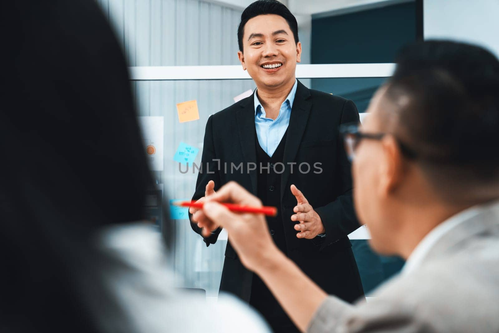 Successful businessman presents his financial plan and data analyst with confident. Group of executive managers asking questions. Office Conference room meeting. Board room. Intellectual.