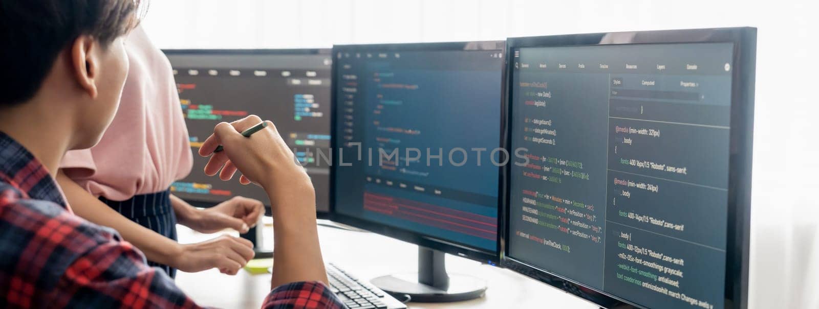 Cropped image of professional programer team collaboration discuss about web coding while coworker point java script displayed on computer at modern company office. Closeup. Burgeoning.