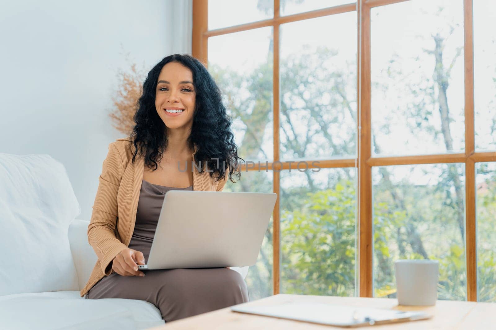 African-American woman using laptop computer for crucial work by biancoblue