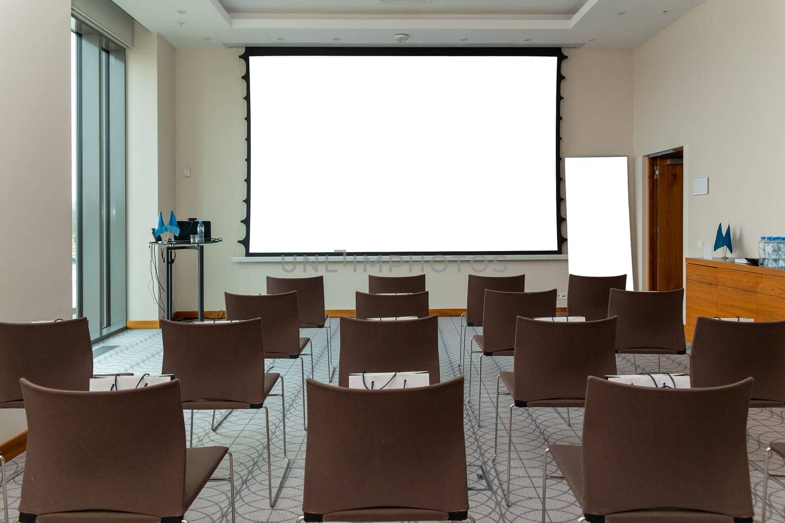 Mock up projector screen. Modern presentation interior conference room. Business meeting. Office building.