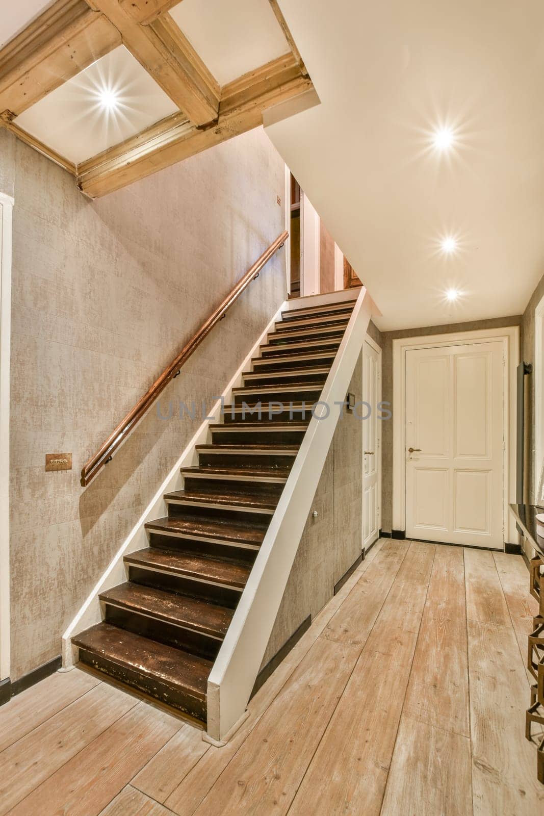 a staircase in a house with wood floors and a by casamedia
