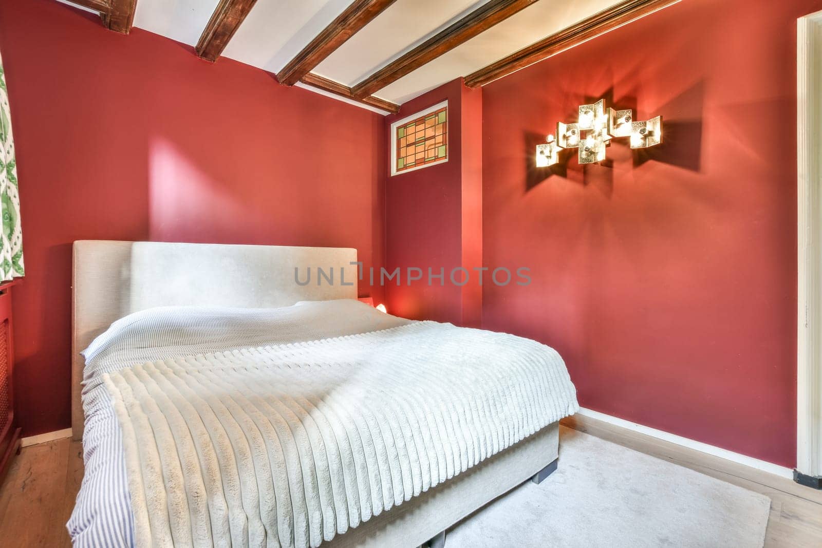 a bedroom with red walls and a white bed by casamedia