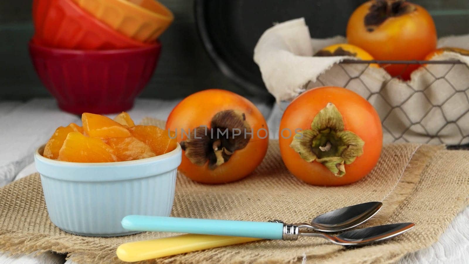 Fresh ripe persimmon on a wooden table.