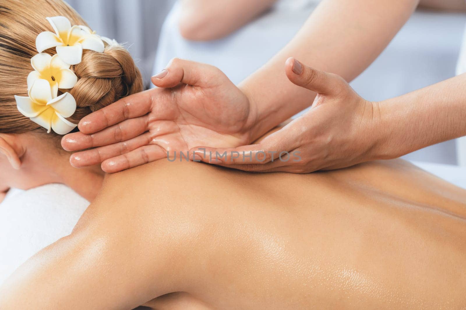 Closeup caucasian couple customer enjoying relaxing anti-stress spa massage and pampering with beauty skin recreation leisure in day light ambient salon spa at luxury resort or hotel. Quiescent