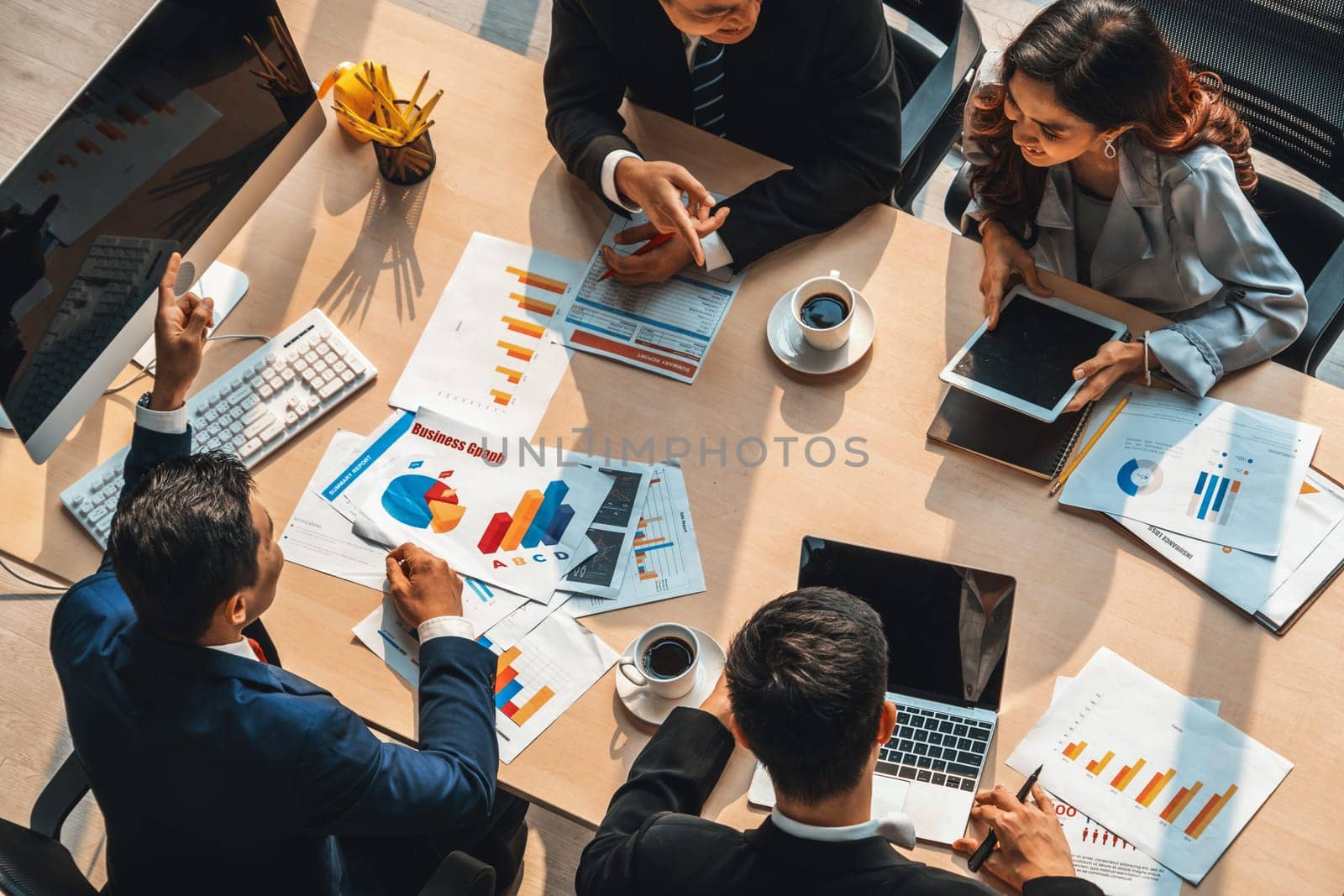 Business people group meeting shot from top view in office . Profession businesswomen, businessmen and office workers working in team conference with project planning document on meeting table . Jivy