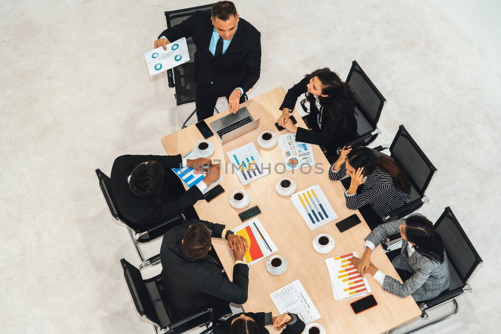 Business people group meeting shot from top view in office . Profession businesswomen, businessmen and office workers working in team conference with project planning document on meeting table . Jivy