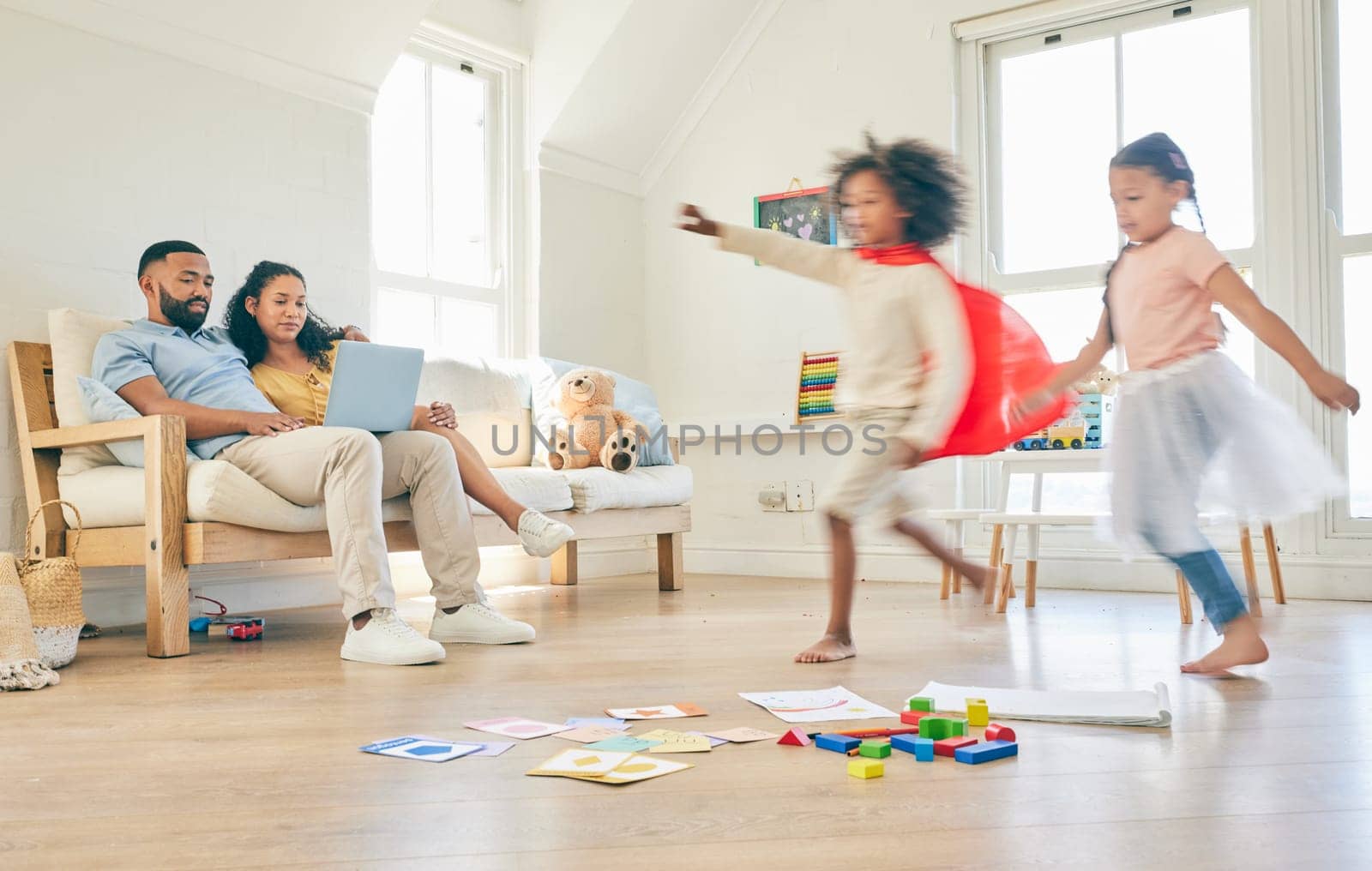 Parents on laptop, happy family and running children playing pretend games, fun or imagine being superhero, princess or ballerina. Speed energy, Halloween fantasy costume and young kids play at home.