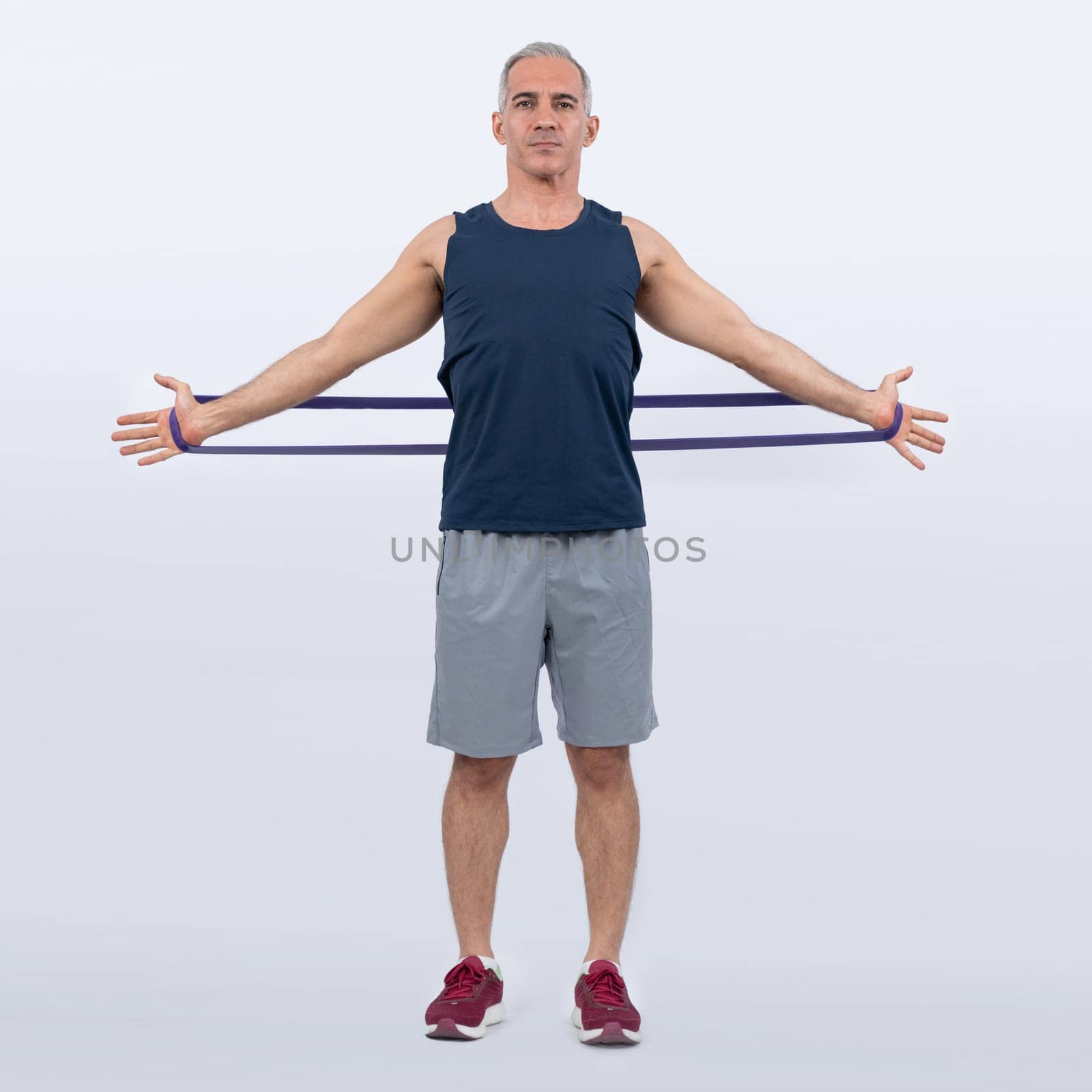 Full body length shot athletic and sporty senior man with resistance band. Clout by biancoblue