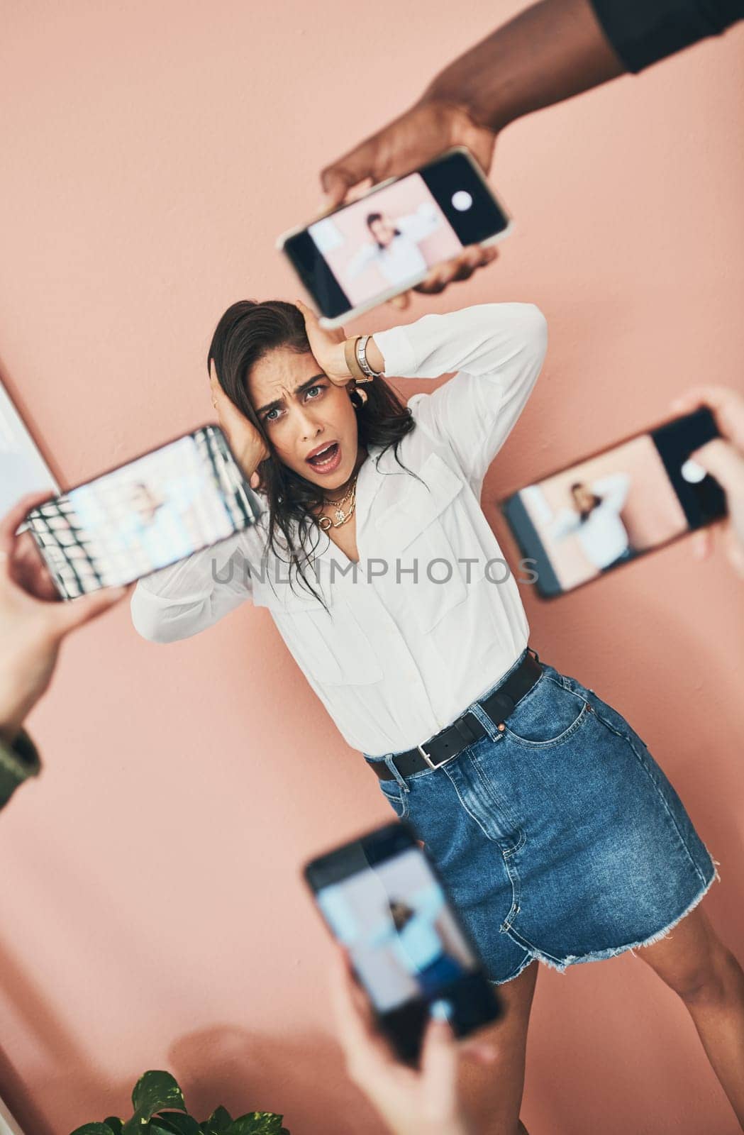 Were doing a post on the best cellphone camera. a beautiful young woman having her picture taken on multiple phones