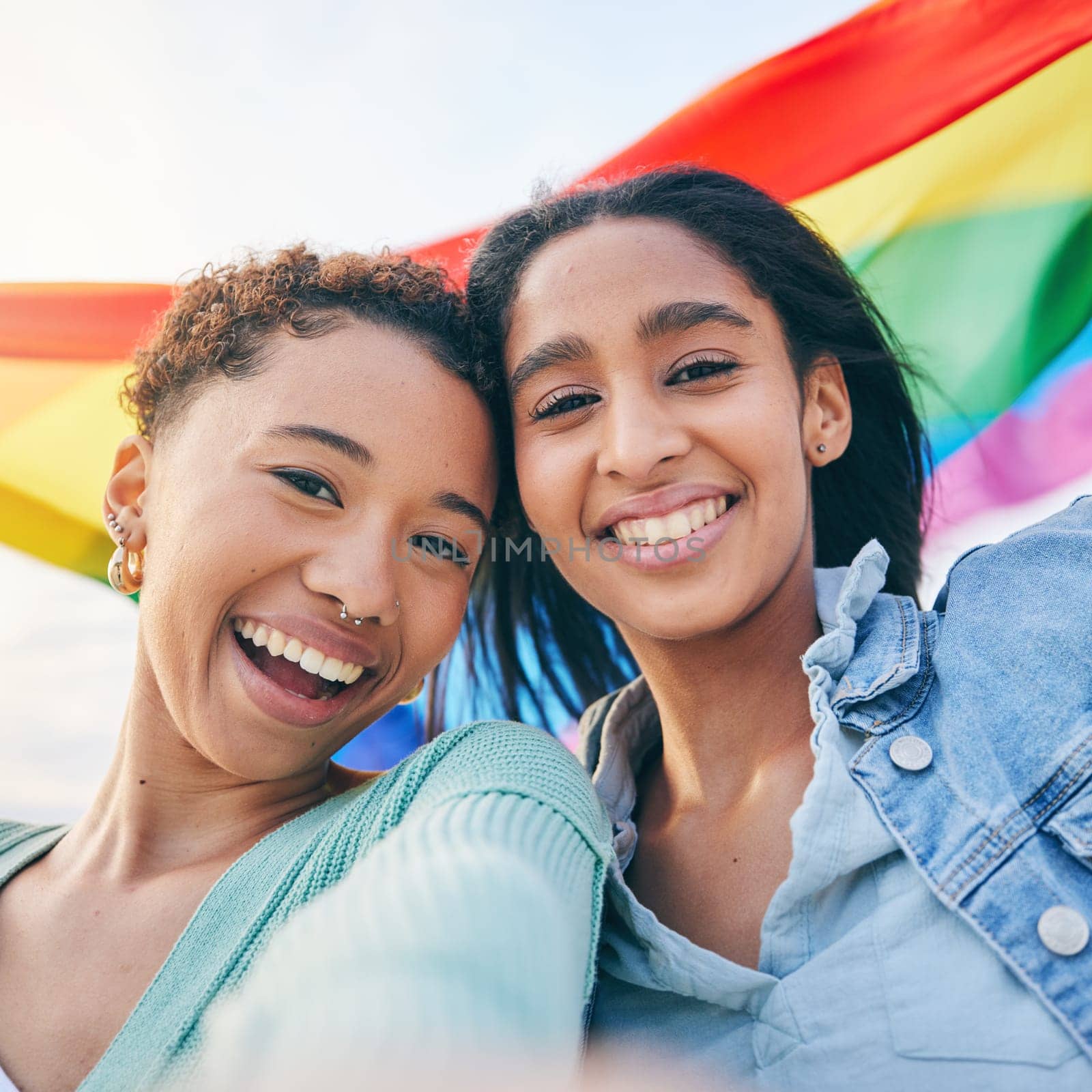Portrait, couple and lesbian with women in selfie, pride flag and lgbt relationship, happiness outdoor. Female people smile in picture, gen z youth and gay equality, support and trust with partner.