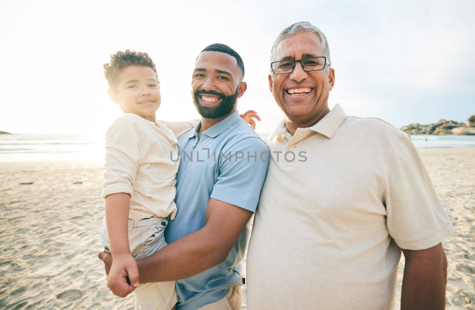 Summer, portrait and family at the beach in the morning for walking, travel or holiday in Spain. Smile, sunshine and father, child and grandfather at sea for a vacation, care and time at the ocean.
