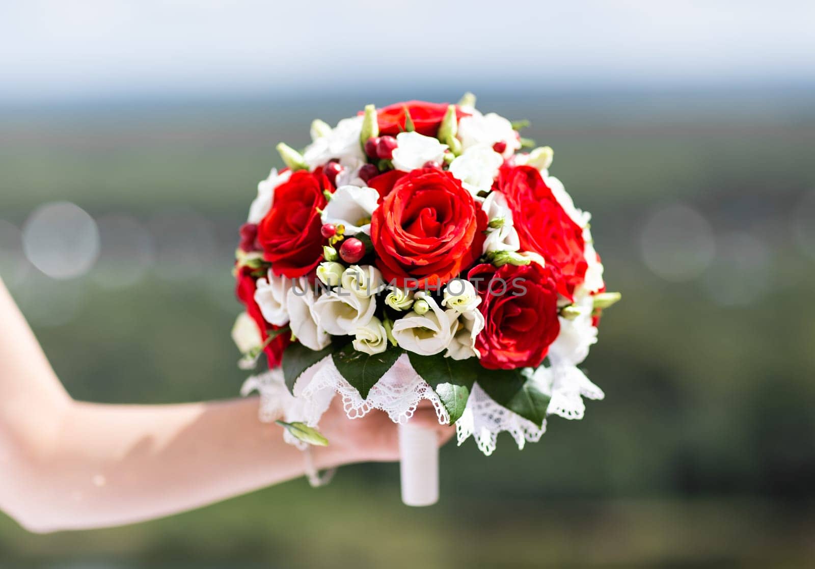 Beautiful wedding bouquet in hands of the bride.