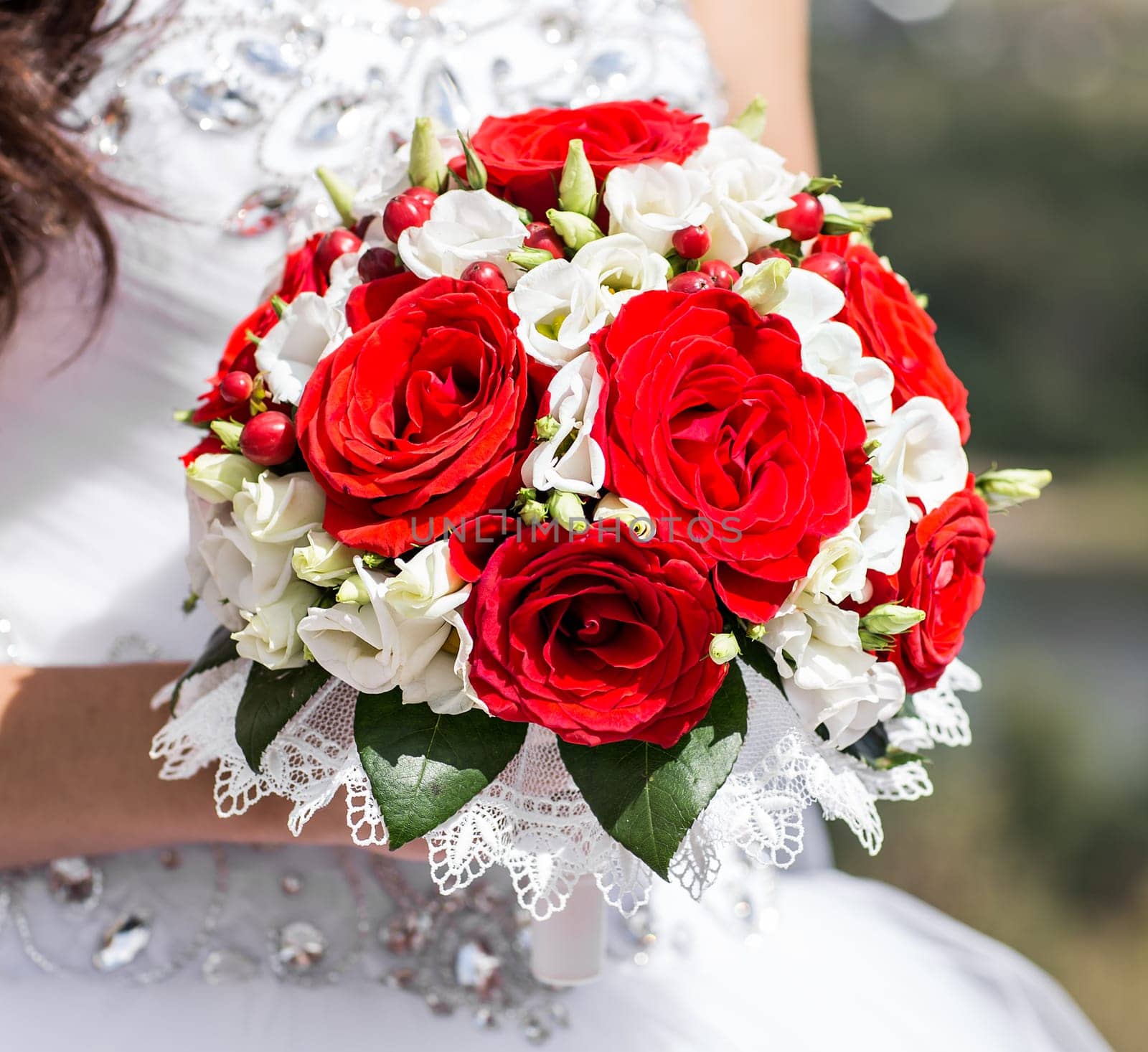 Beautiful wedding bouquet in hands of the bride.