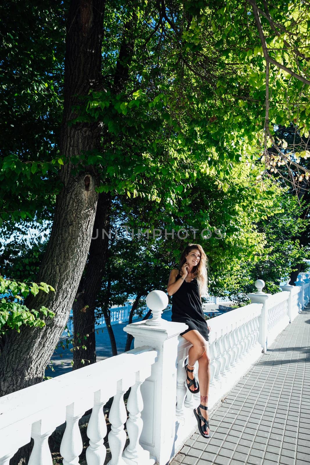 beautiful woman near white railings on a walk travel vacation by Simakov