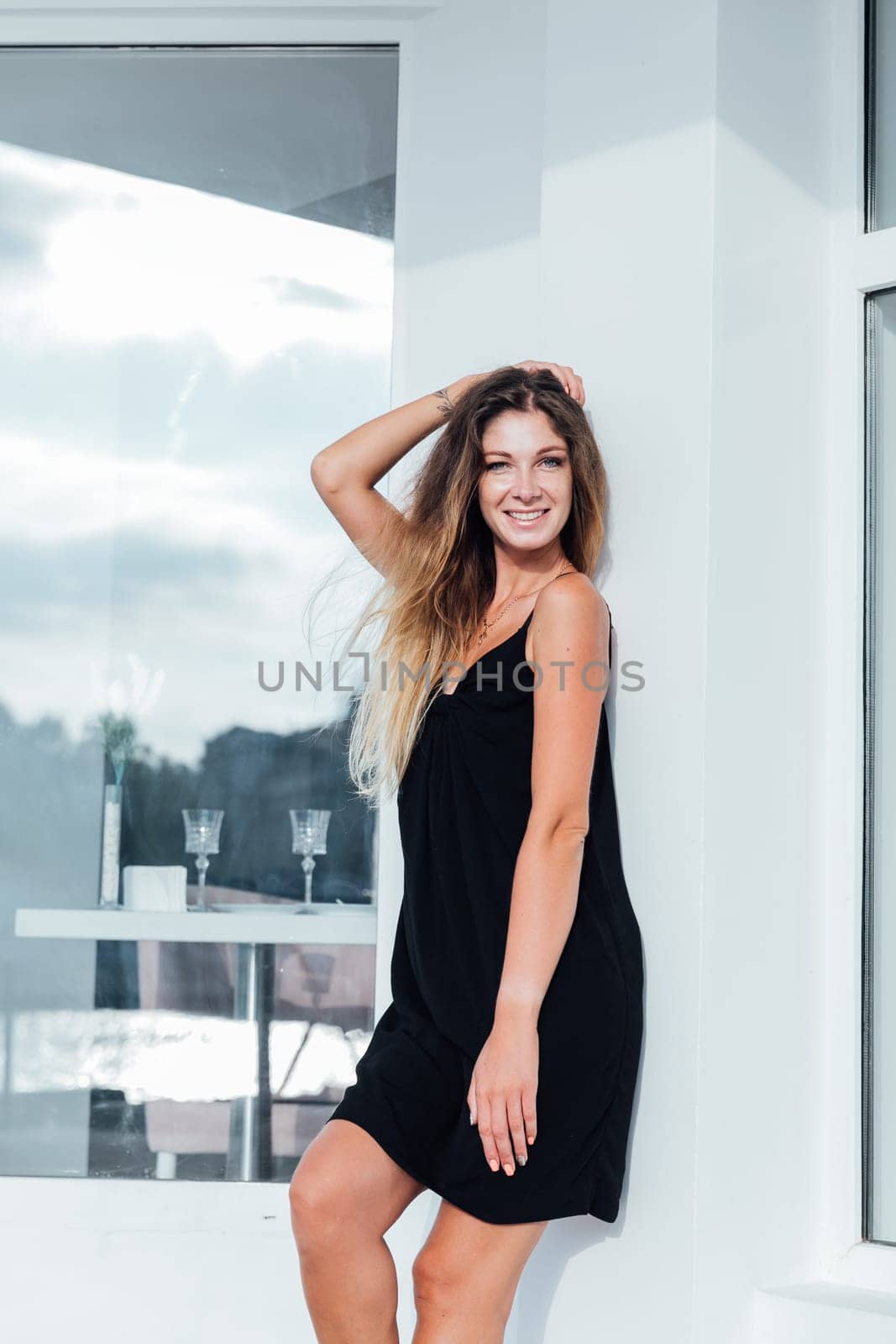 a woman stands near a restaurant walk rest by Simakov