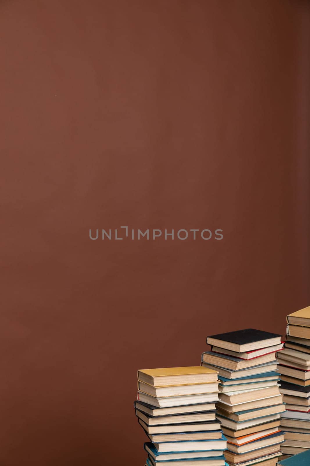 learning literacy science education stack of books on a brown background by Simakov