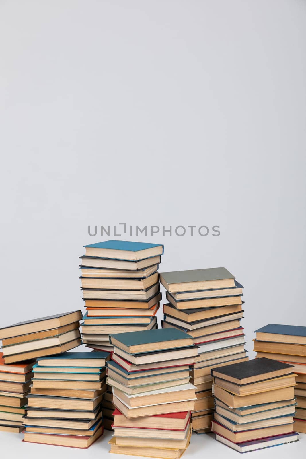 science education stack of books on white background teaching literacy by Simakov