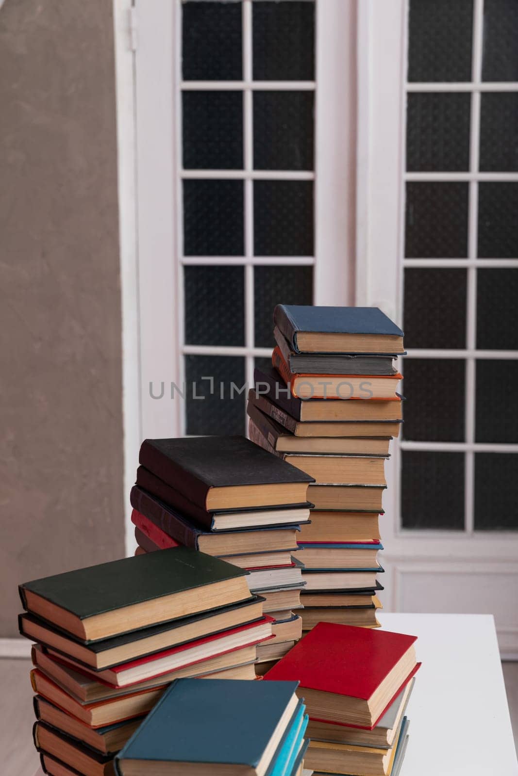 stack of books at the door in the library education science training by Simakov