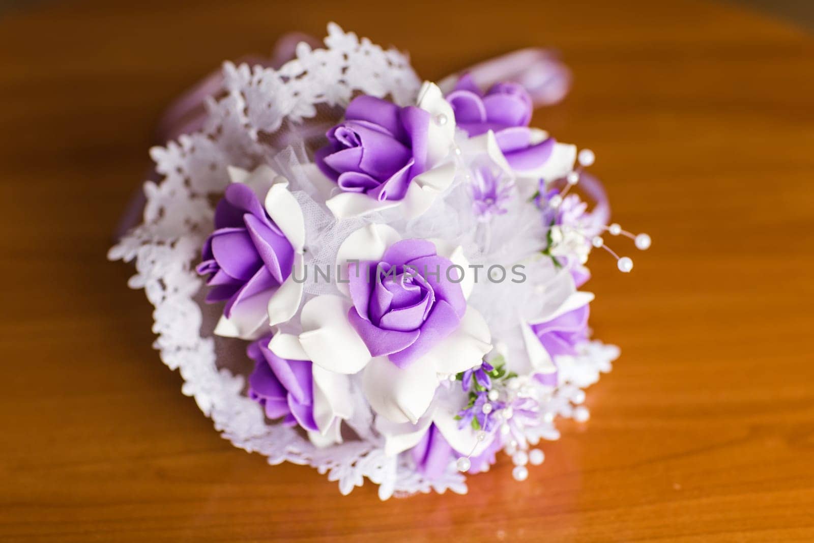 Beautiful purple artificial wedding bridal flowers bouquet.