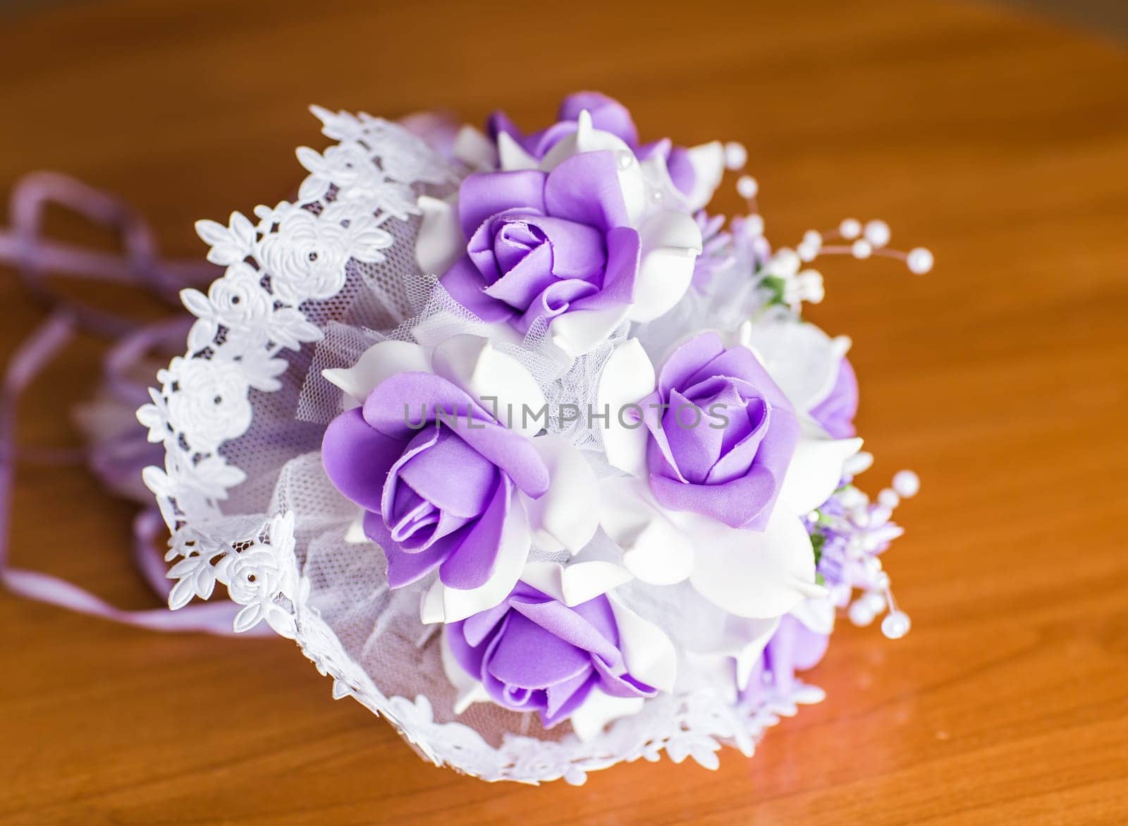 Beautiful purple artificial wedding bridal flowers bouquet.