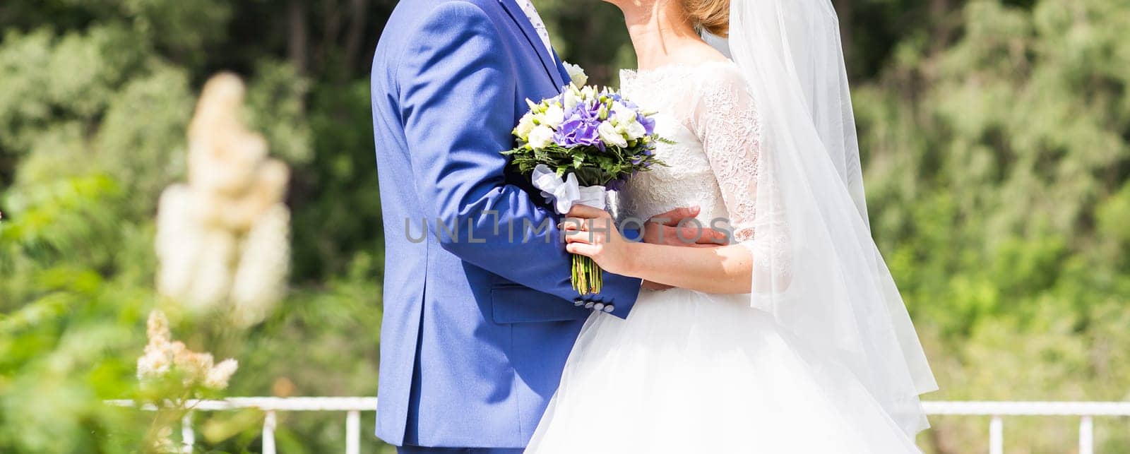 Beautiful wedding bouquet in hands of the bride close-up by Satura86