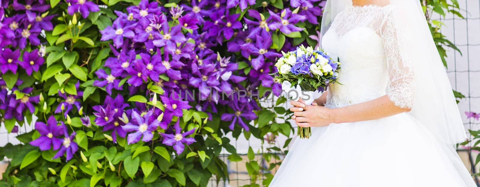 Beautiful wedding bouquet in hands of the bride close-up by Satura86