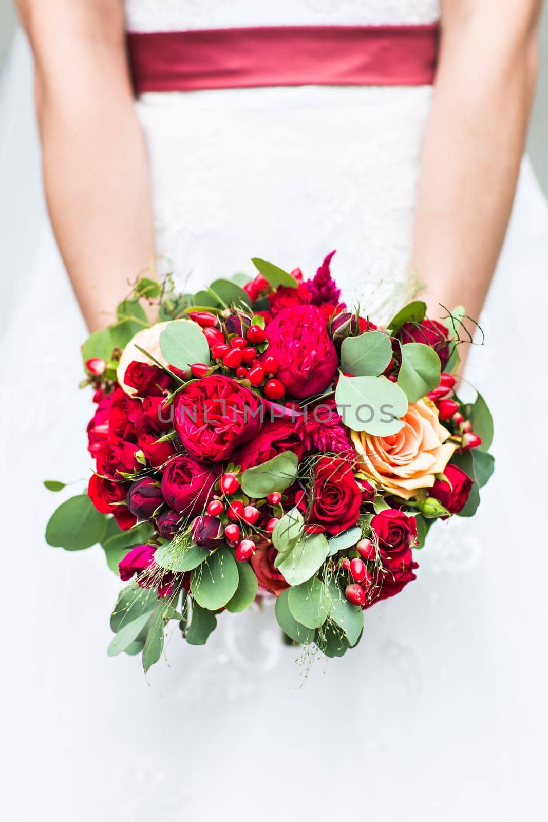 Beautiful wedding bouquet in hands of the bride close-up by Satura86