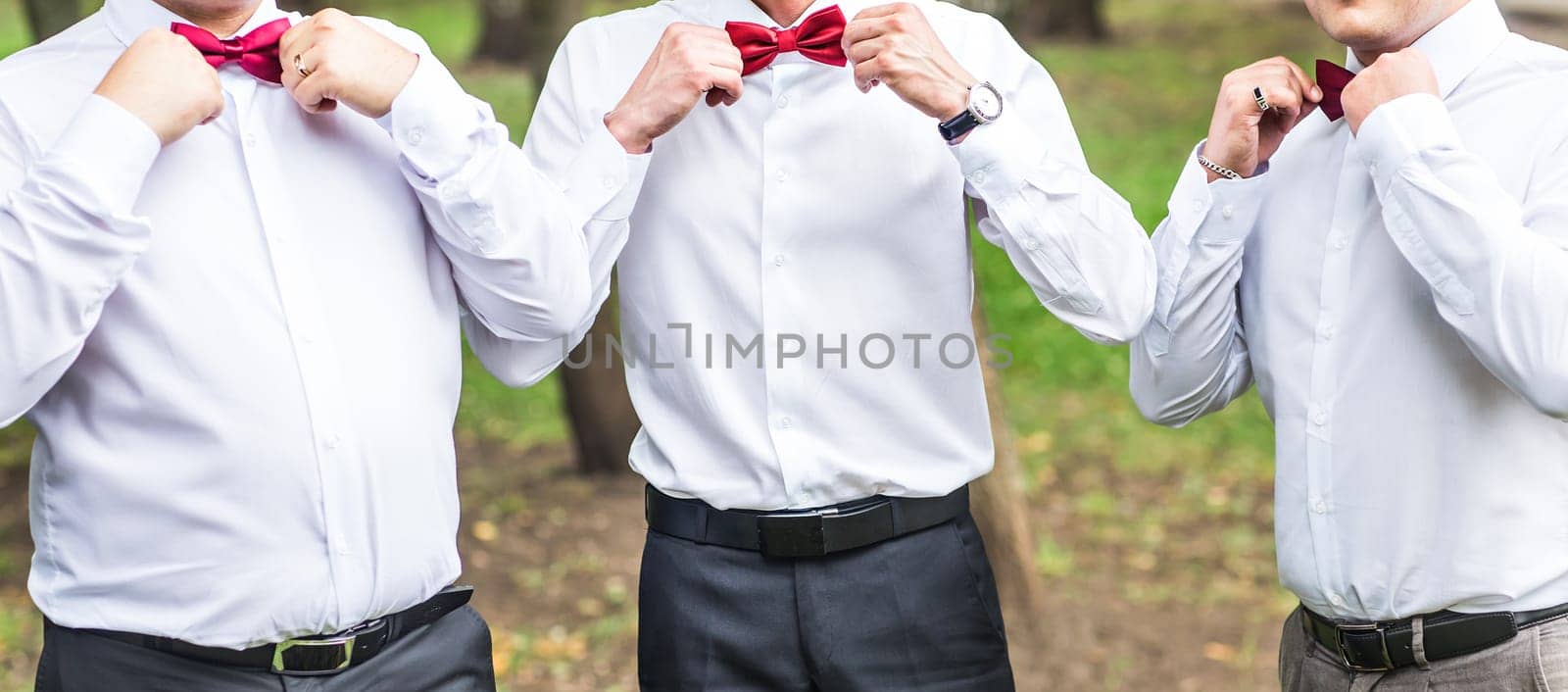 Group of young men with bow tie. Cheerful friends. friends outdoors. Wedding day