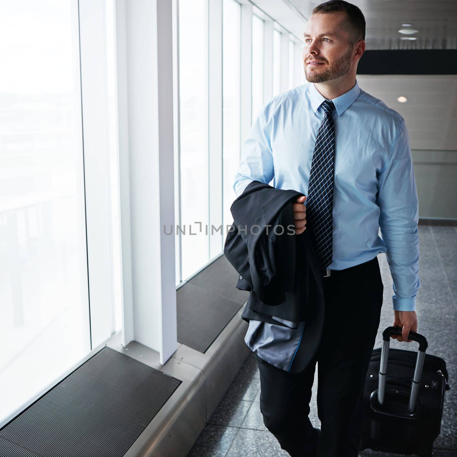 Walking, flight or businessman in airport thinking of company trip with suitcase or luggage for commute. Proud manager, idea or corporate worker in hall for journey or international travel by window.