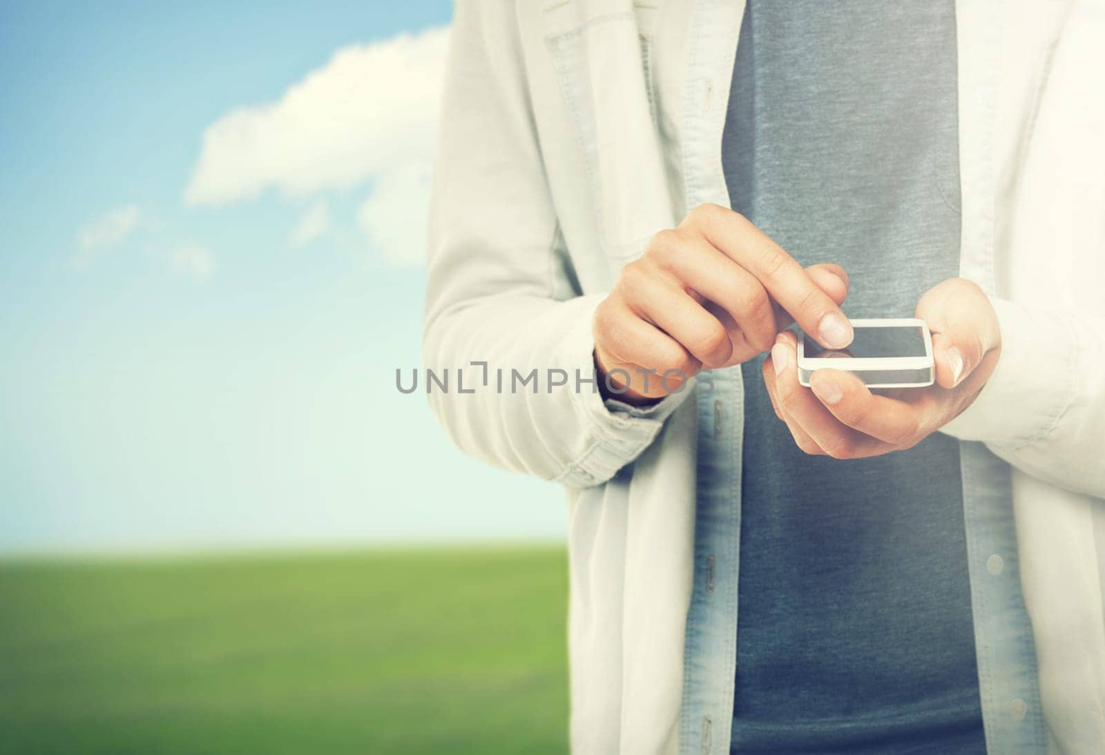 Hands, phone and space with a person in the countryside on a nature or blue sky background for communication. Social media, environment and an adult outdoor on a green field for networking closeup.