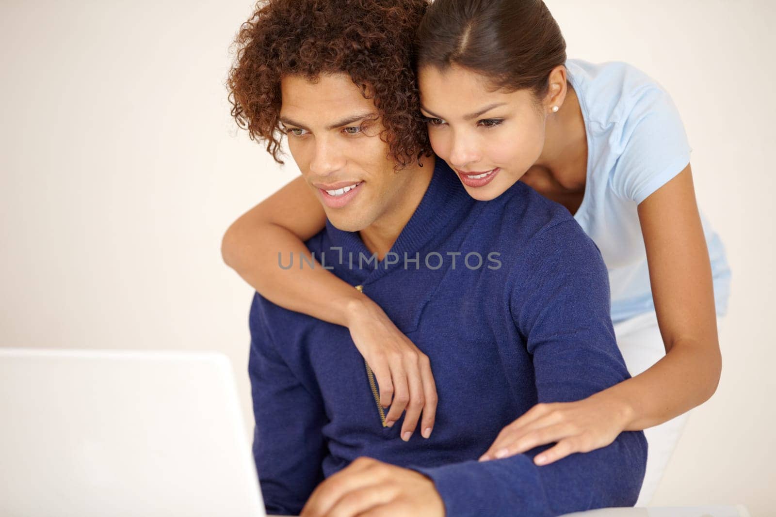 Hug, happy and couple on laptop for online shopping, browse internet and social networking together. Dating, love and man and woman embrace on computer for reading website, streaming service and blog.